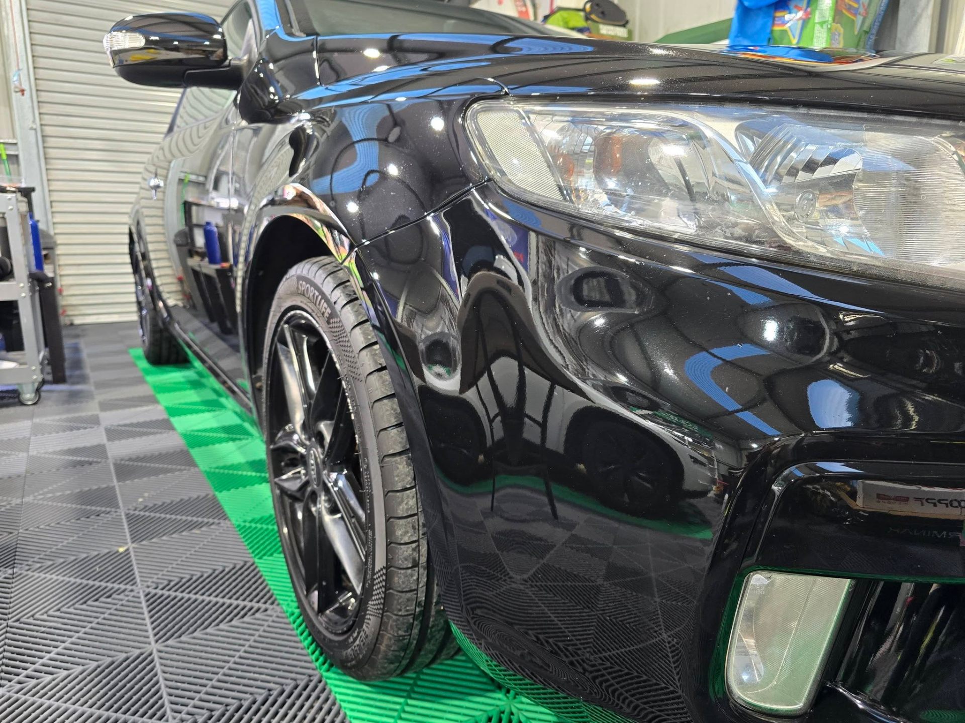 Black Kia in the Kisses Detailing studio bay