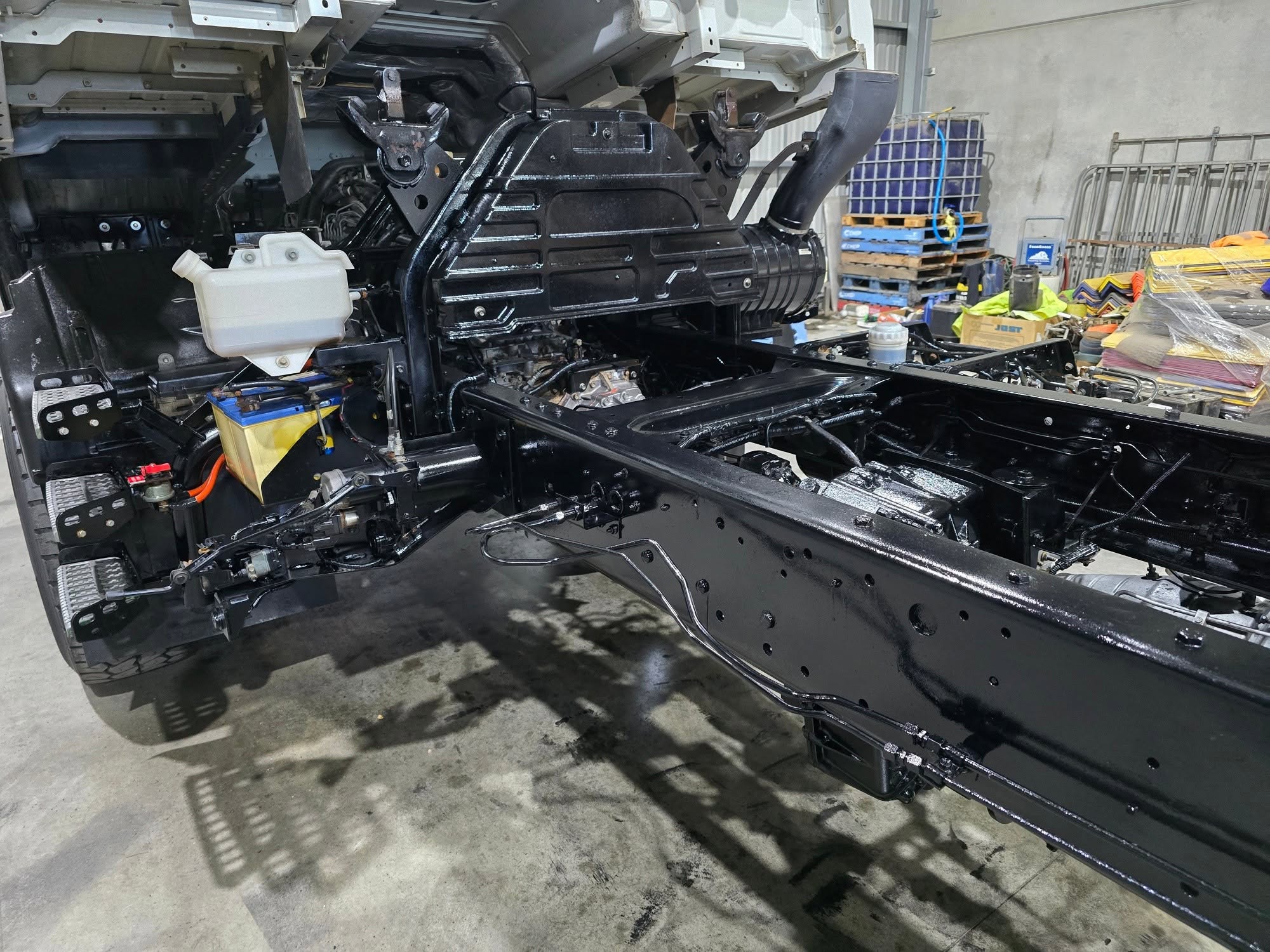 Truck chassis detail — engine bay and frame coated