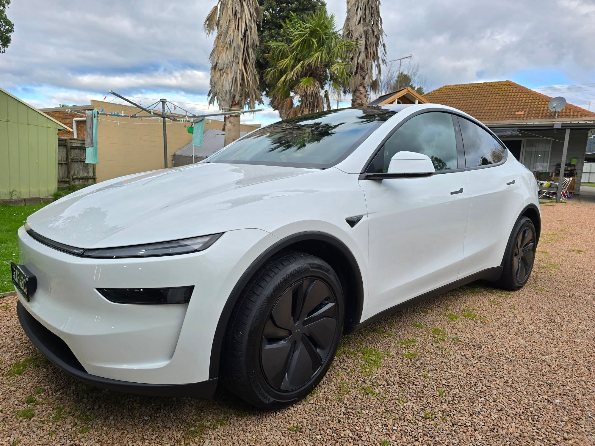 White Tesla Model Y outdoors after detail